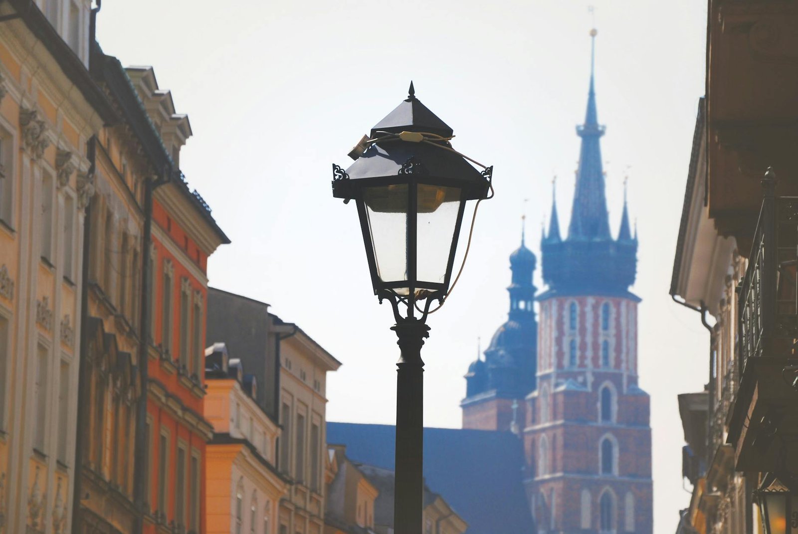 Historic street in Kraków, Poland with St. Mary's Basilica