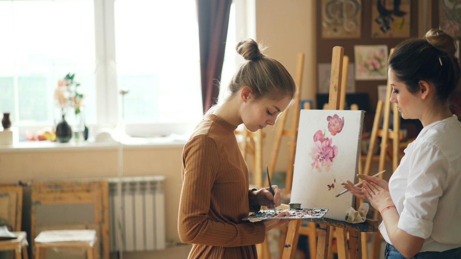 Young women painting in an art studio